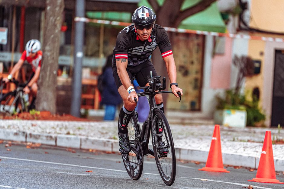 Cyclist competing in an urban road race, demonstrating focus and athleticism.